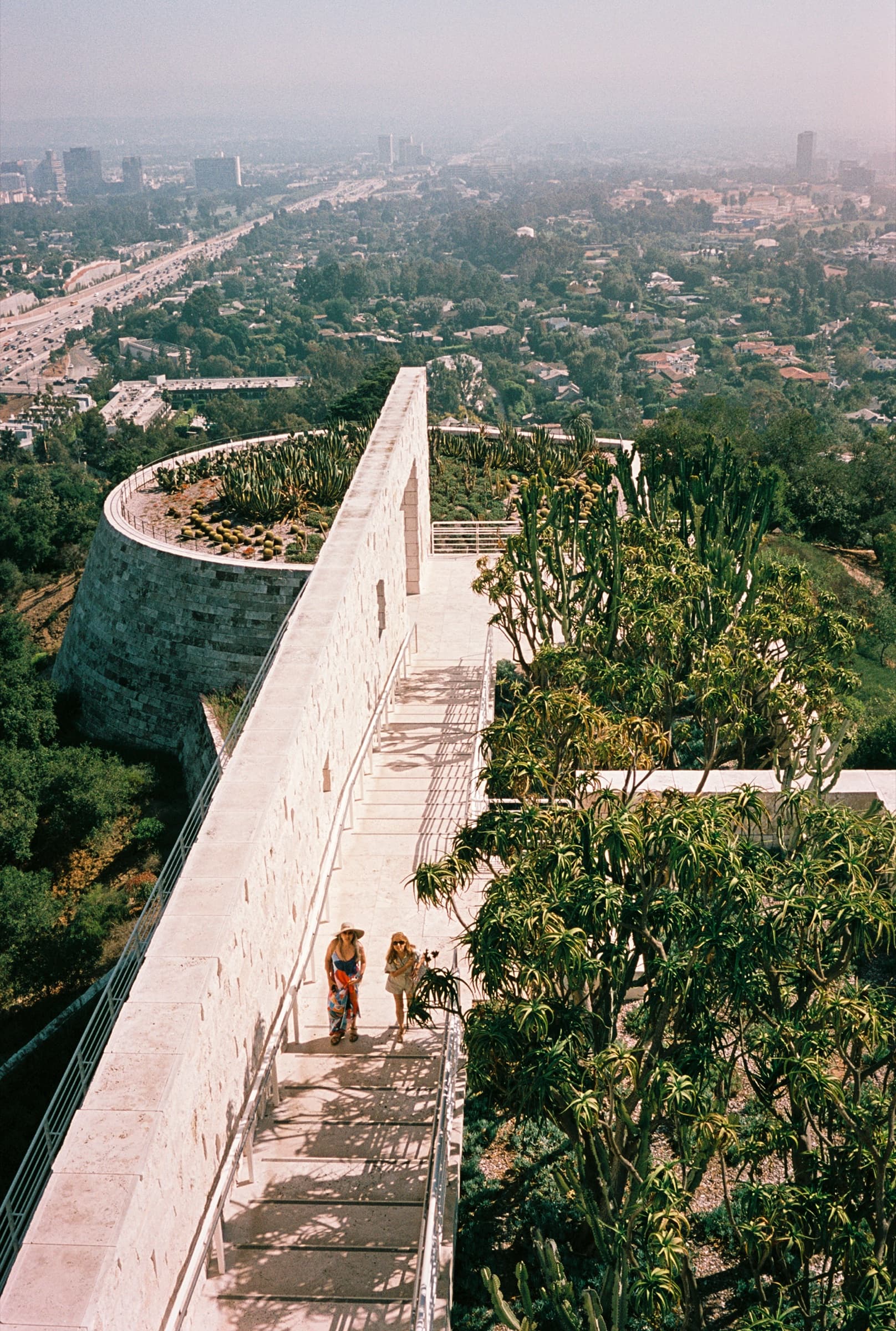 A person resting on the Getty Center terrace high above the fog-blanketed Los Angeles basin