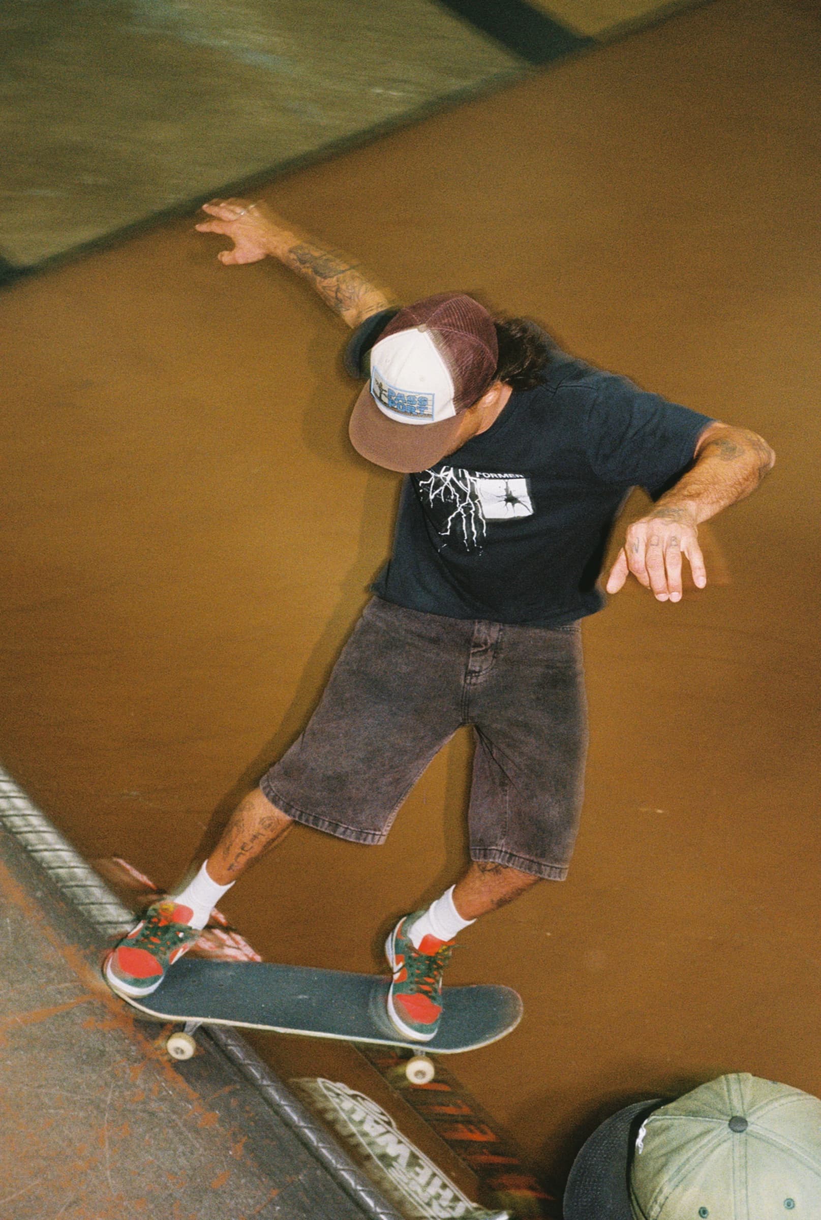 Skateboarder grinding a rail at the Skate Park of Tampa