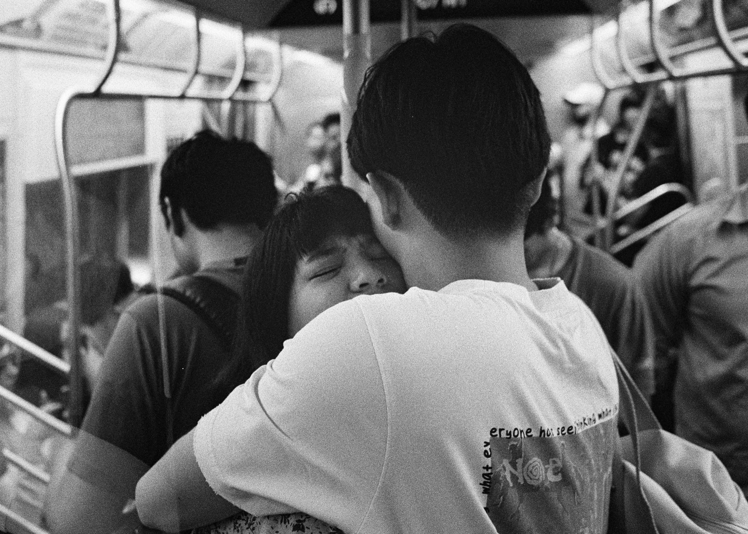 Couple embracing on an MTA subway train in New York