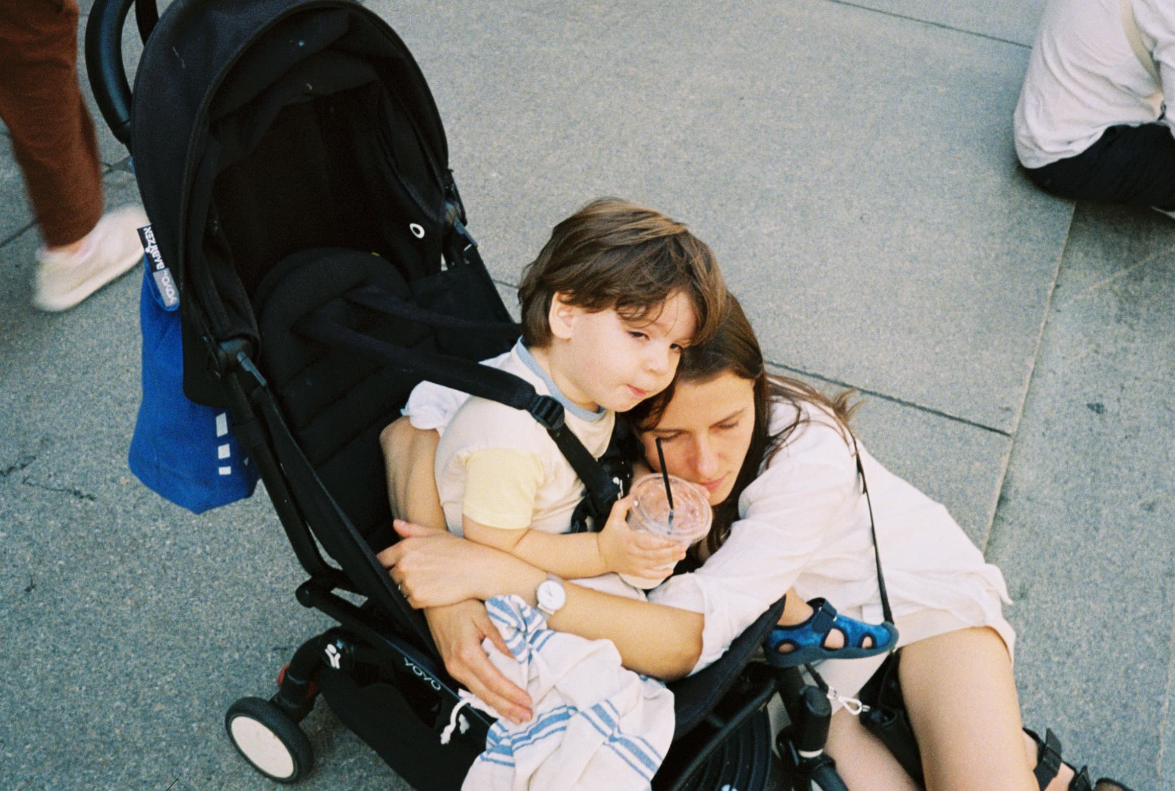 Mother and child embracing on the steps of The Met in New York