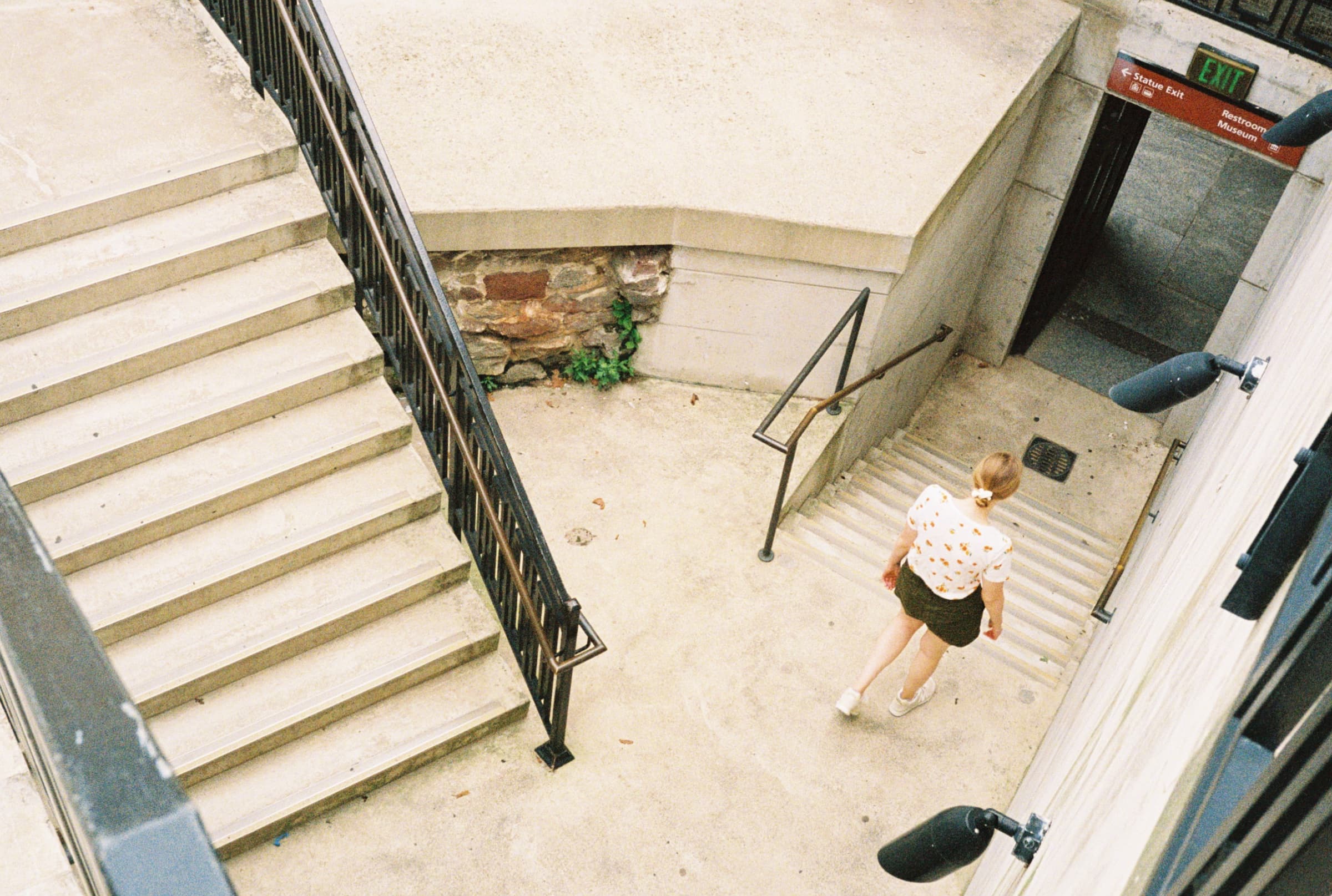 Woman ascending the zig-zag staircase inside the Statue of Liberty in New York